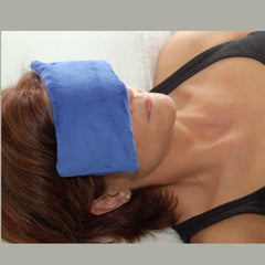 Eye pillow resting on bed or spa setting